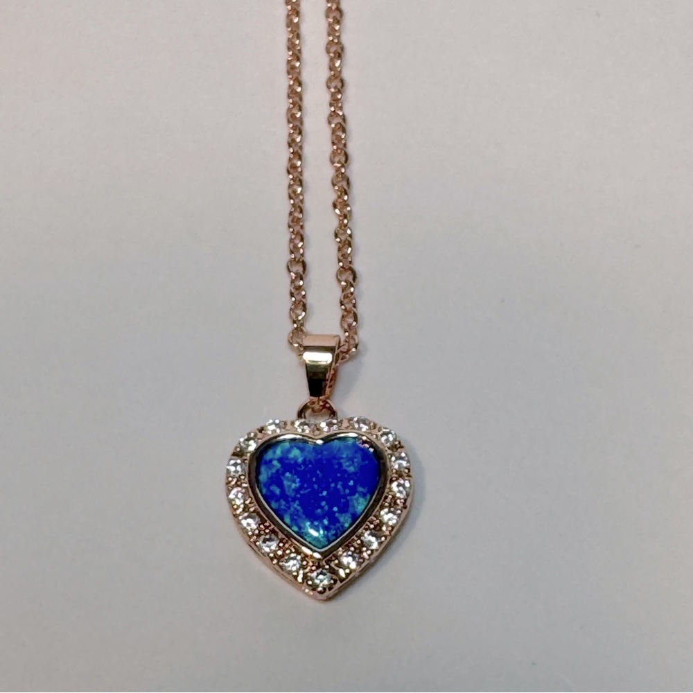 Blue topaz heart necklace costume jewelry on rose gold tone chain.